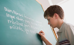 Boy writing on blackboard